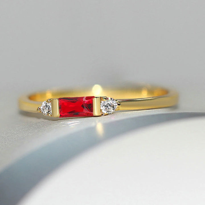Red central stone with golden and shiny ring